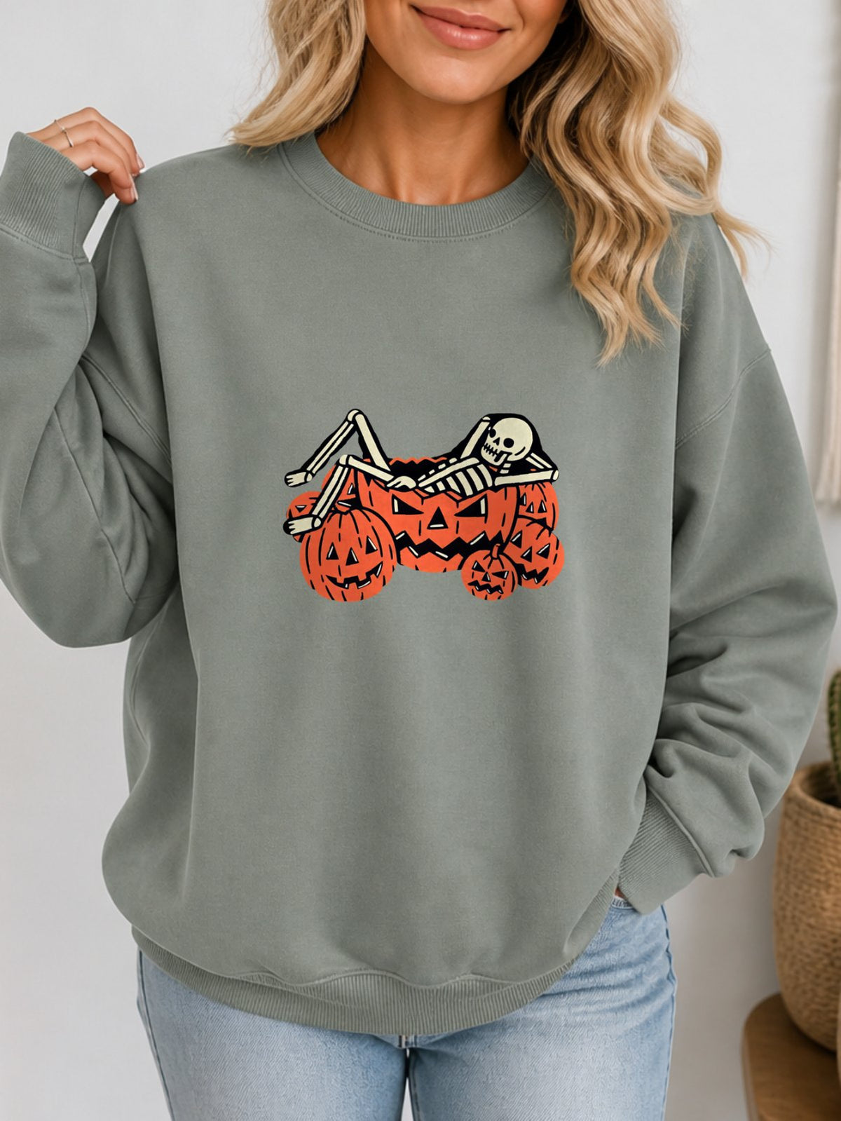 Skeleton Chilling In Pumpkin Retro Graphic Sweatshirt - Hanes_Stonewashed_Green Model