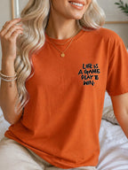 Life Is A Game Play To Win Hand Lettering Graphic T-Shirt - Texas Orange Model