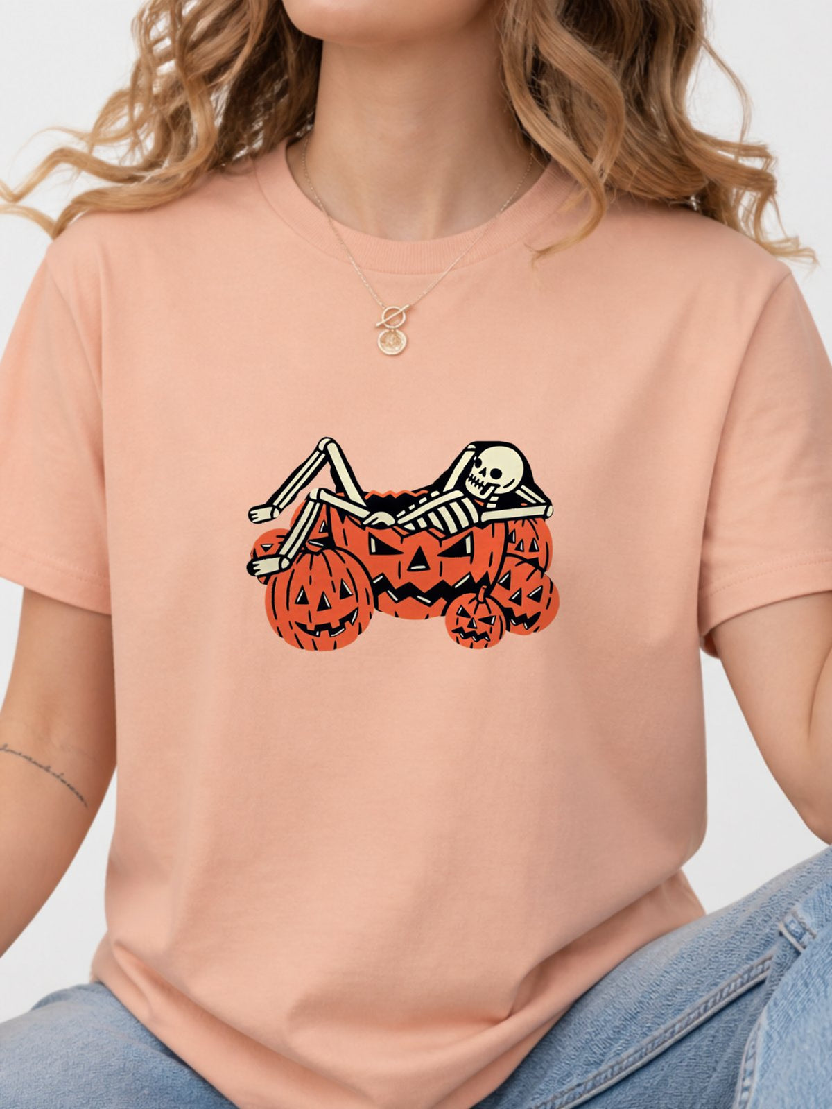 Skeleton Chilling In Pumpkin Graphic Tee - Dusty Rose Model